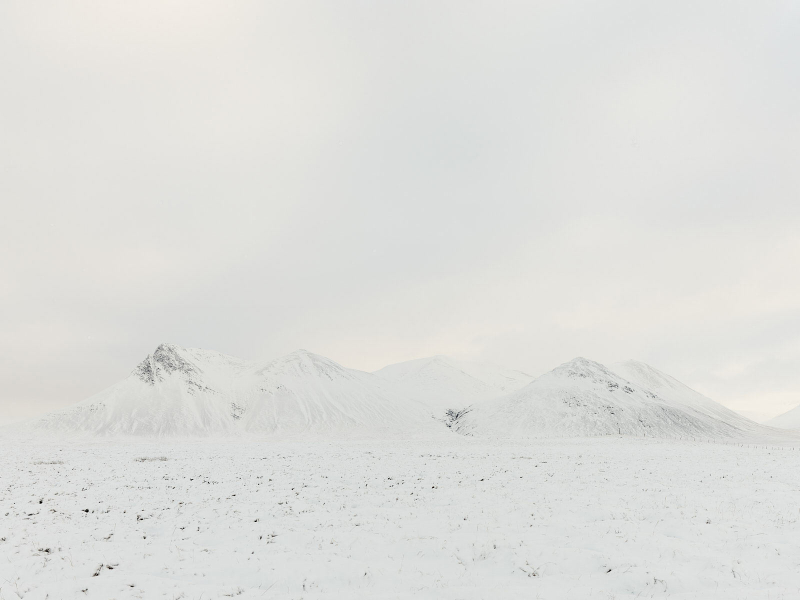 An all-white mountain landscape, its ridgeline dissolving into atmosphere—Peter Voigt’s exploration of form and perception in nature.